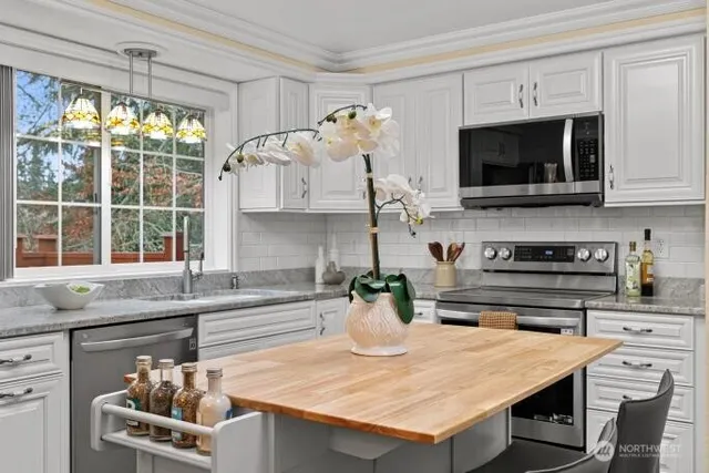 a kitchen with a stove a sink and a microwave