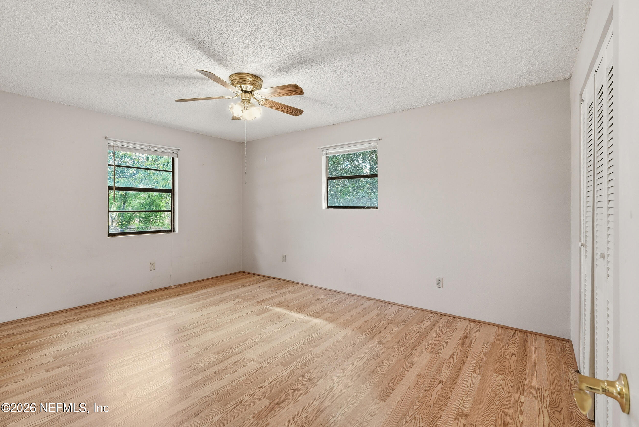 7593 Silver Sands Road Keystone Heights, FL 32656 - Photo 17 of 36 an empty room with windows and fan