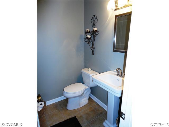10649 Honey Tree Road Richmond, VA 23235 - Photo 11 of 12 Other - This is the downstairs renovated half bathroom with a pedestal sink and a new tile floor.