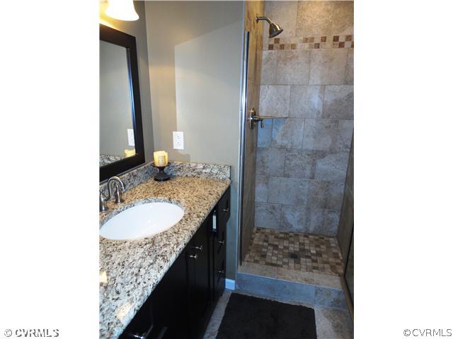 10649 Honey Tree Road Richmond, VA 23235 - Photo 4 of 12 Master Bath - The master bath was recently redone with a walk-in shower with decorative tile, tile floor, and a granite topped vanity.