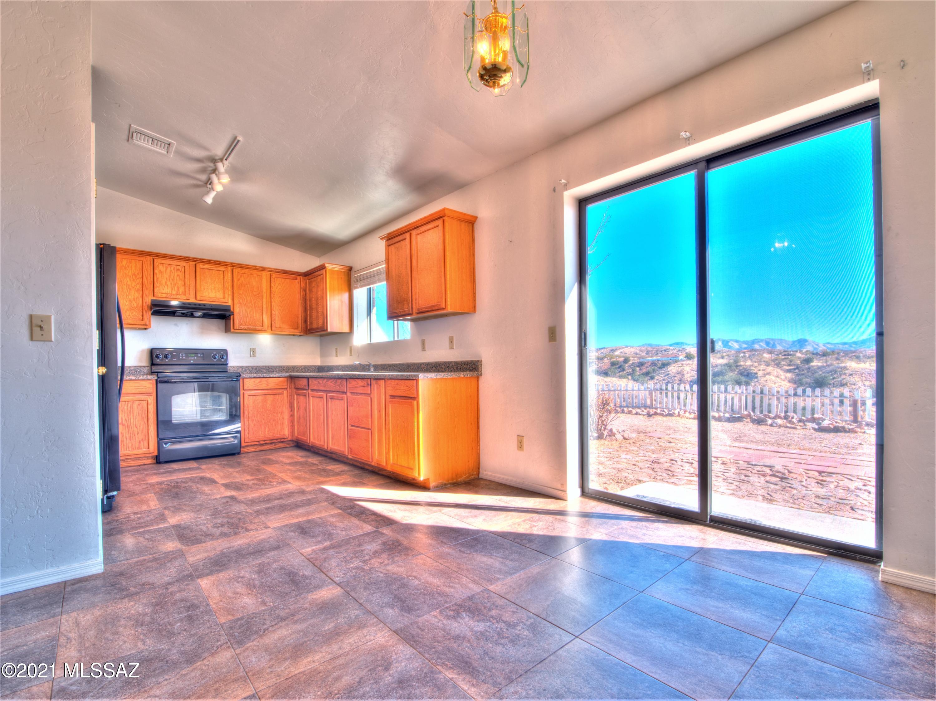 381 Tala Court Rio Rico, AZ 85648 - Photo 9 of 19 a large kitchen with stainless steel appliances granite countertop a refrigerator and a sink