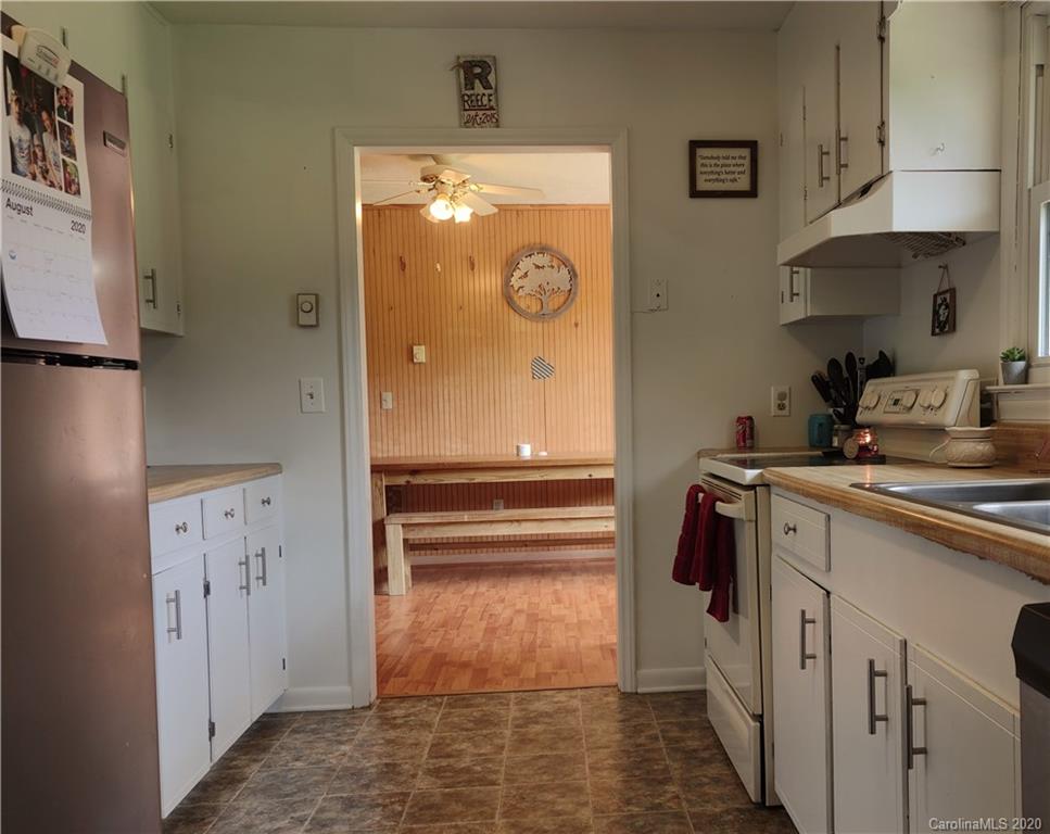 152 Willis Hill Road Canton, NC 28716 - Photo 11 of 34 a kitchen with a refrigerator and cabinets