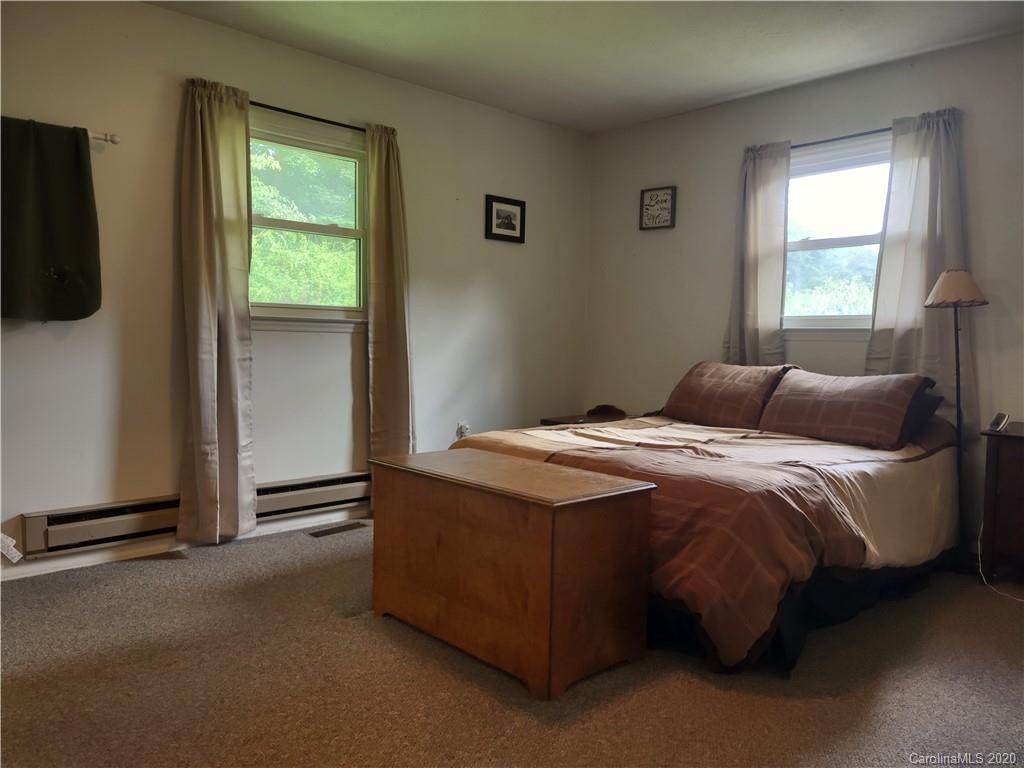 152 Willis Hill Road Canton, NC 28716 - Photo 12 of 34 a bedroom with a bed and a window