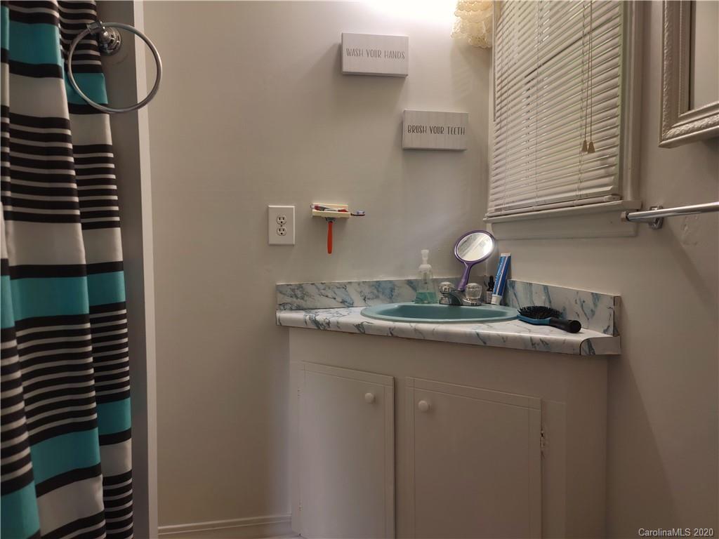 152 Willis Hill Road Canton, NC 28716 - Photo 13 of 34 a bathroom with a granite countertop sink and a mirror