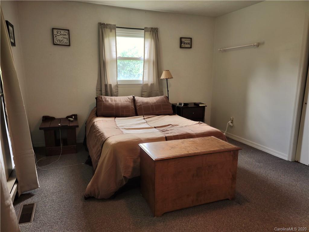 152 Willis Hill Road Canton, NC 28716 - Photo 14 of 34 a bedroom with a bed and a window