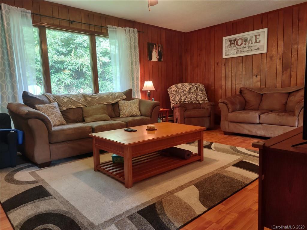 152 Willis Hill Road Canton, NC 28716 - Photo 17 of 34 a living room with furniture and a large window