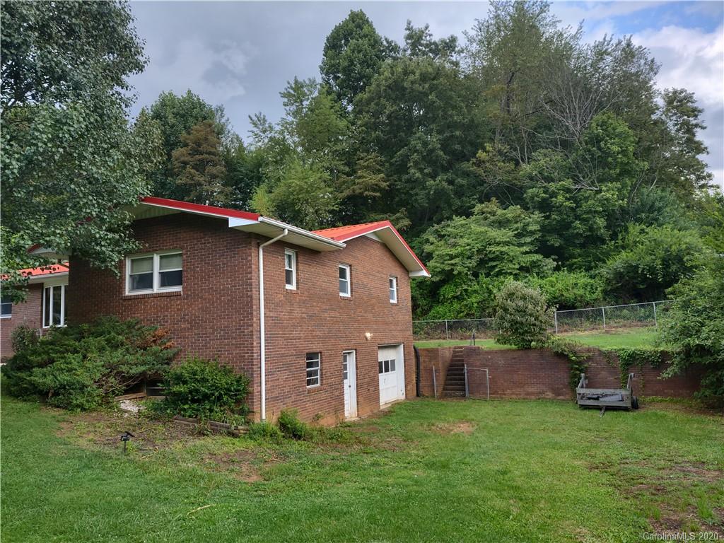 152 Willis Hill Road Canton, NC 28716 - Photo 22 of 34 a aerial view of a house with yard and trees in the background