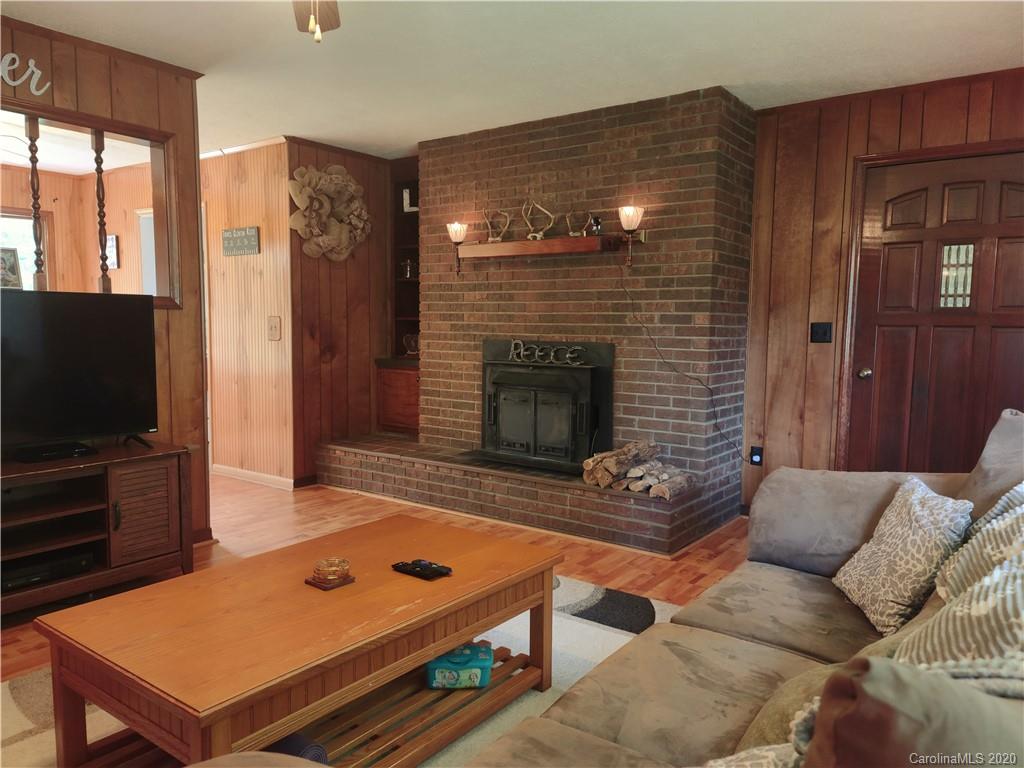 152 Willis Hill Road Canton, NC 28716 - Photo 6 of 34 a living room with furniture a flat screen tv and a fireplace