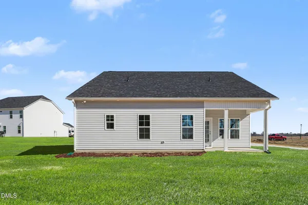 a view of a house with a backyard