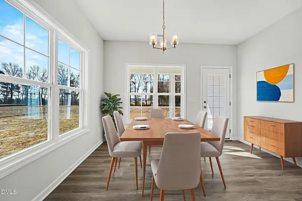 a view of a dining room with furniture window and wooden floor