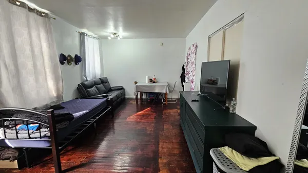 a living room with furniture rug and wooden floor