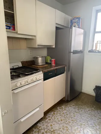 a kitchen with a refrigerator and cabinets
