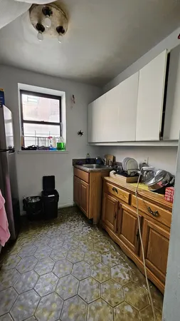 a kitchen with a sink a stove and a refrigerator