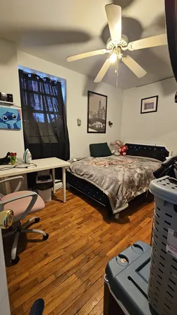 a bedroom with furniture and a flat screen tv