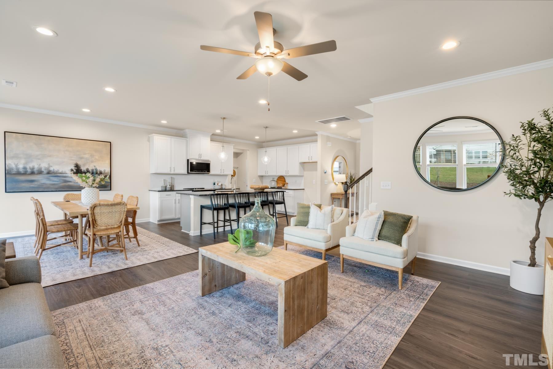 120 Yulan Way Garner, NC 27529 - Photo 18 of 30 a living room with furniture a wooden floor and a chandelier