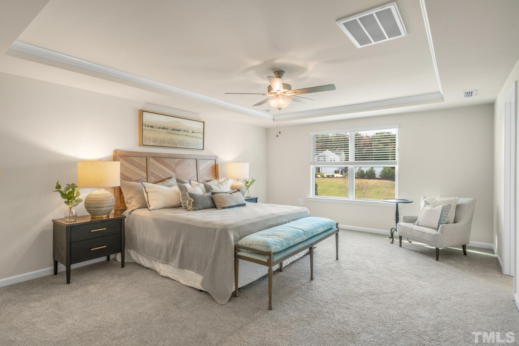 120 Yulan Way Garner, NC 27529 - Photo 20 of 30 a bedroom with a bed couch and window