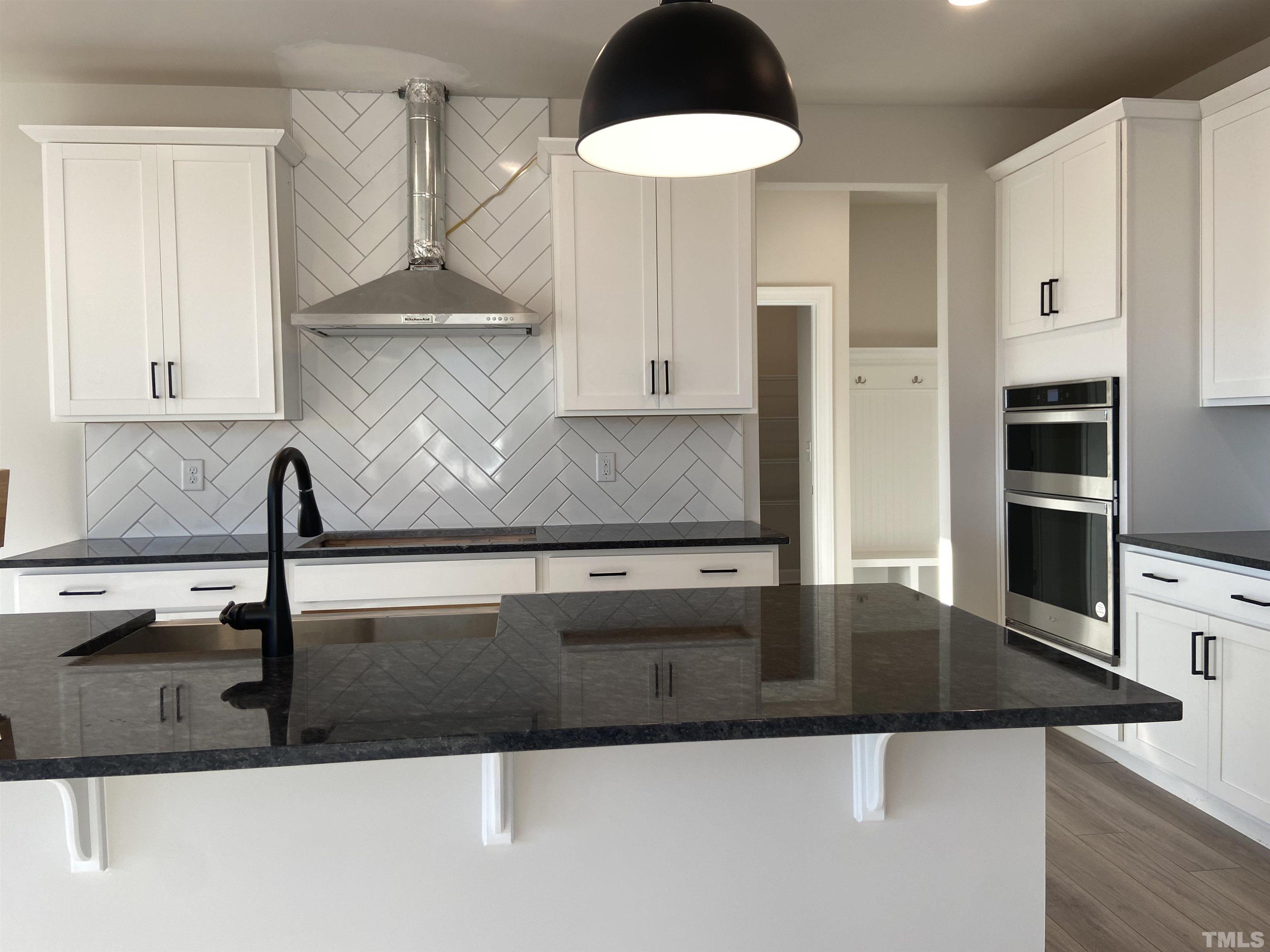 120 Yulan Way Garner, NC 27529 - Photo 4 of 30 a kitchen with stainless steel appliances granite countertop a sink and a refrigerator