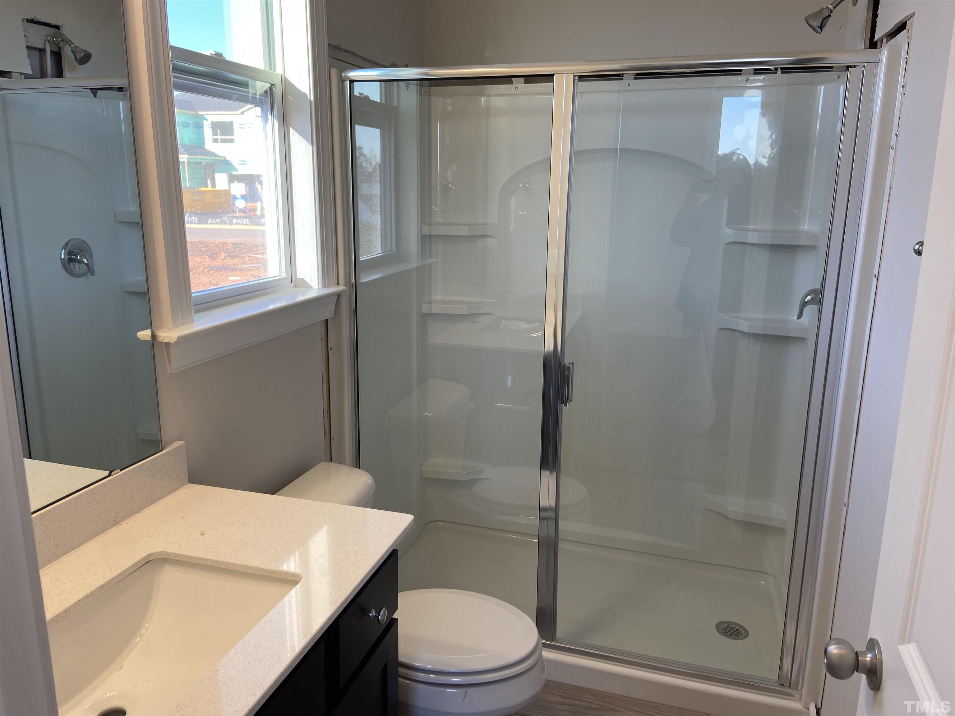 120 Yulan Way Garner, NC 27529 - Photo 6 of 30 a bathroom with a shower a toilet and a sink