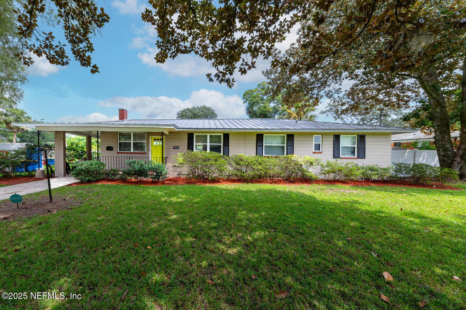 a view of a house with a backyard and a patio