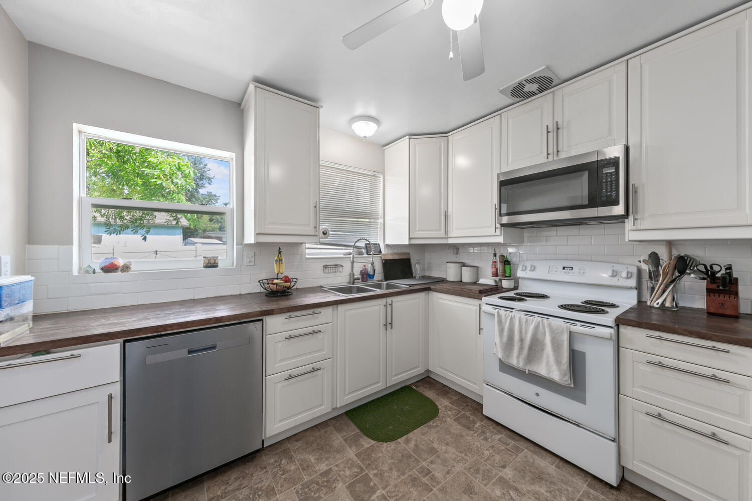 8309 Calento Street Jacksonville, FL 32211 - Photo 11 of 22 a kitchen with stainless steel appliances granite countertop a sink a stove and cabinets