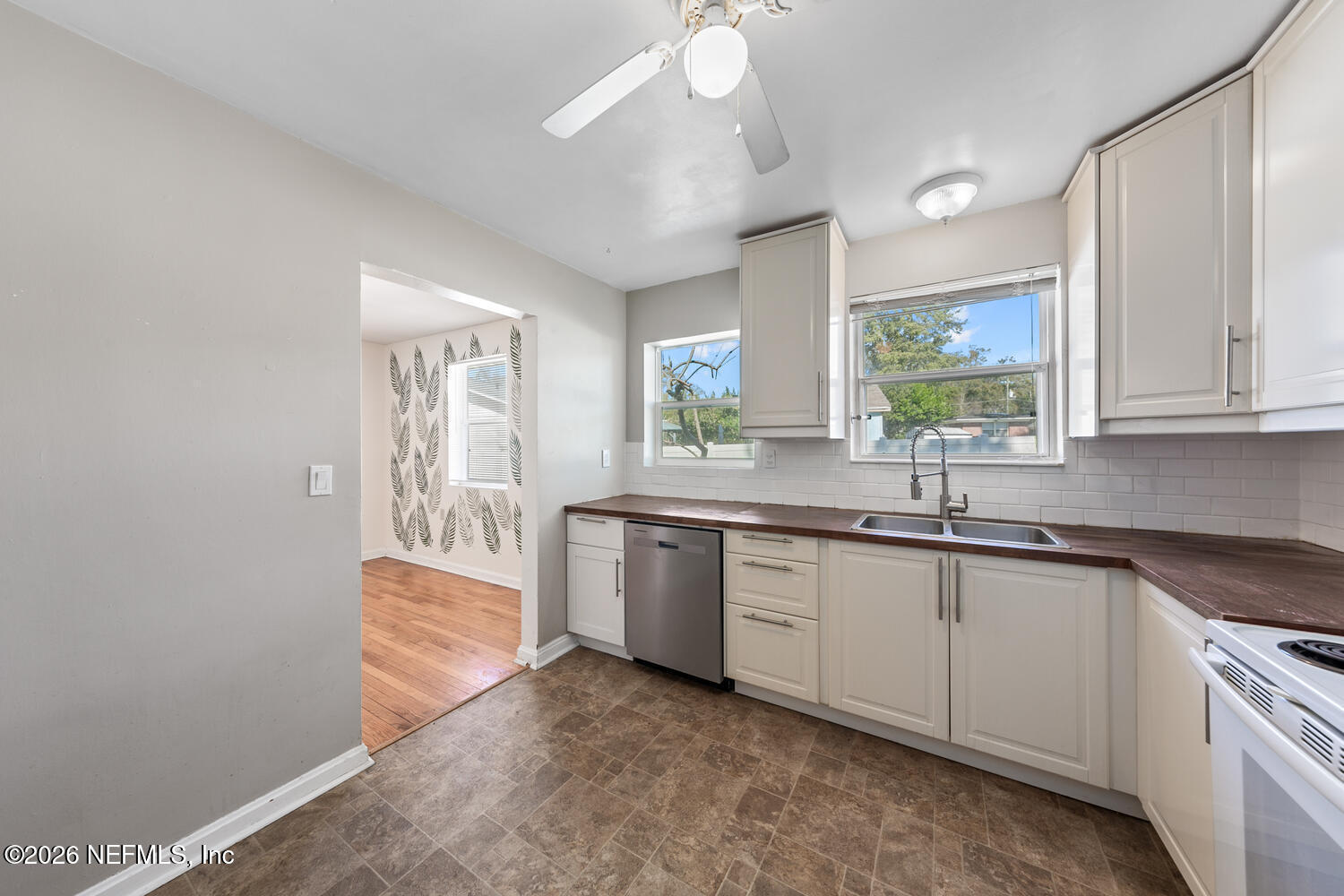 8309 Calento Street Jacksonville, FL 32211 - Photo 12 of 25 a kitchen with granite countertop a sink and white cabinets