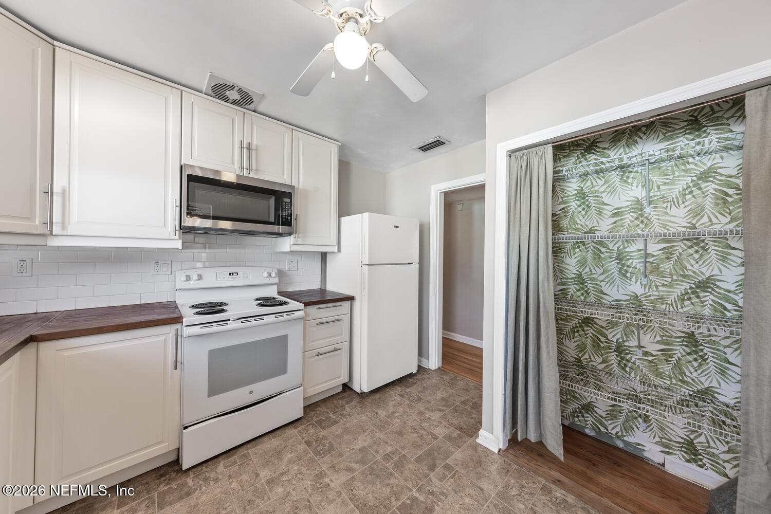 8309 Calento Street Jacksonville, FL 32211 - Photo 13 of 25 a kitchen with a stove a sink and a refrigerator