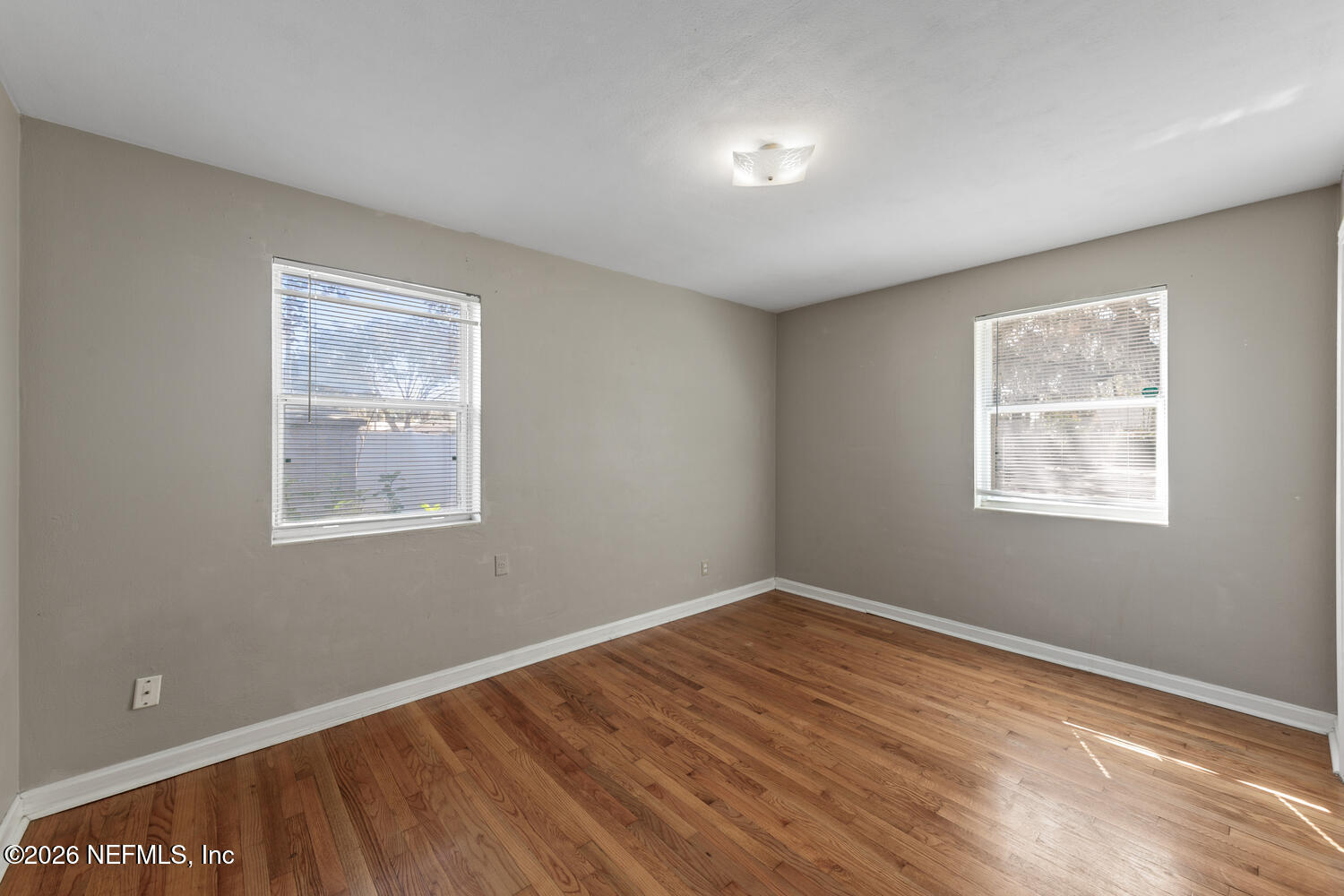 8309 Calento Street Jacksonville, FL 32211 - Photo 15 of 25 a view of a room with wooden floor and windows