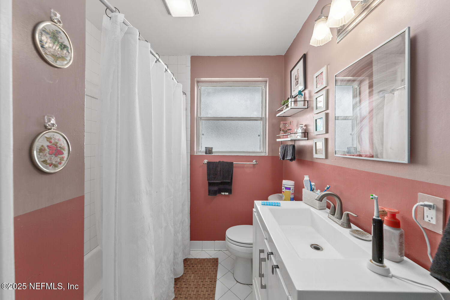 8309 Calento Street Jacksonville, FL 32211 - Photo 16 of 22 a bathroom with a sink a vanity and a mirror