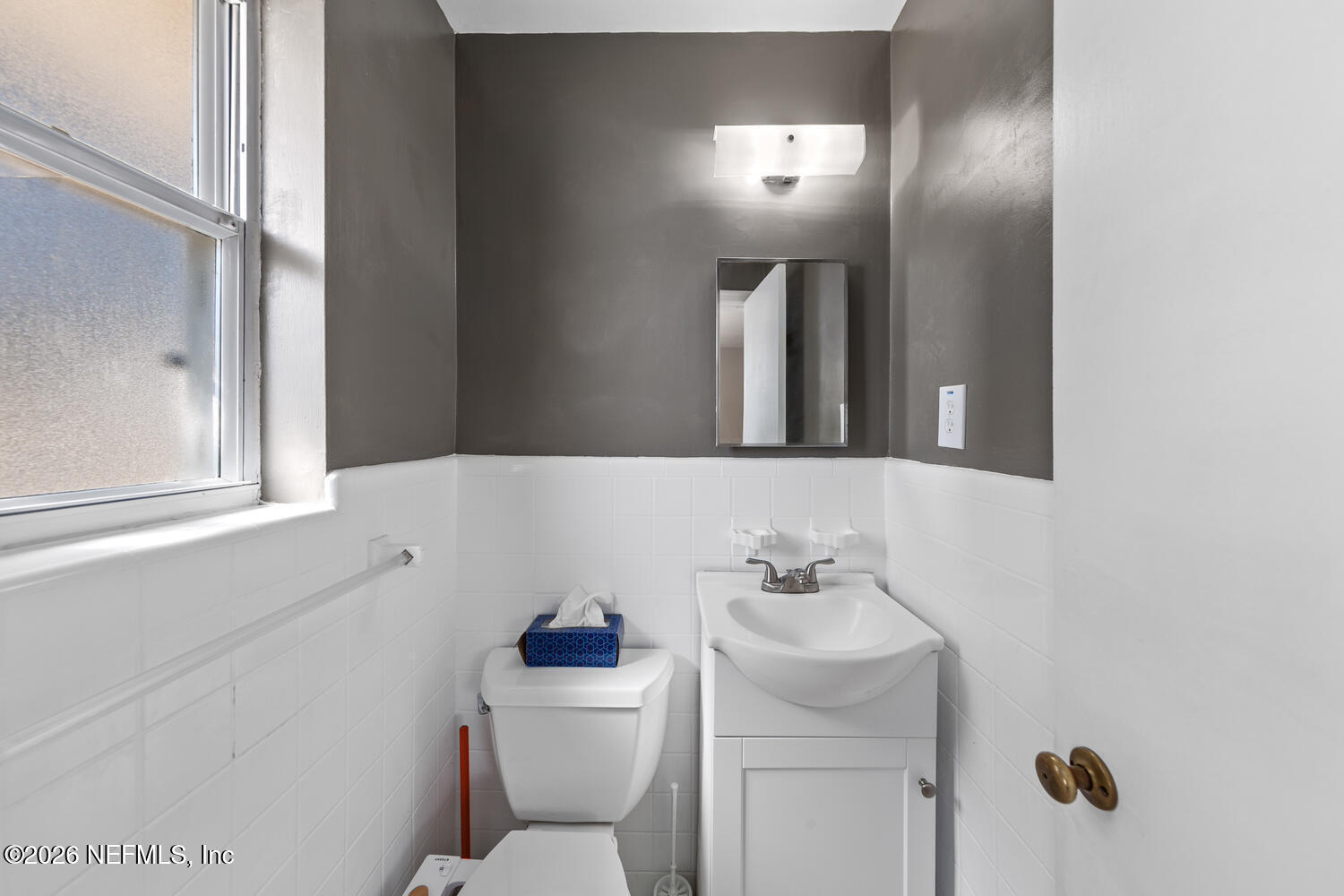 8309 Calento Street Jacksonville, FL 32211 - Photo 17 of 25 a bathroom with a sink toilet and mirror