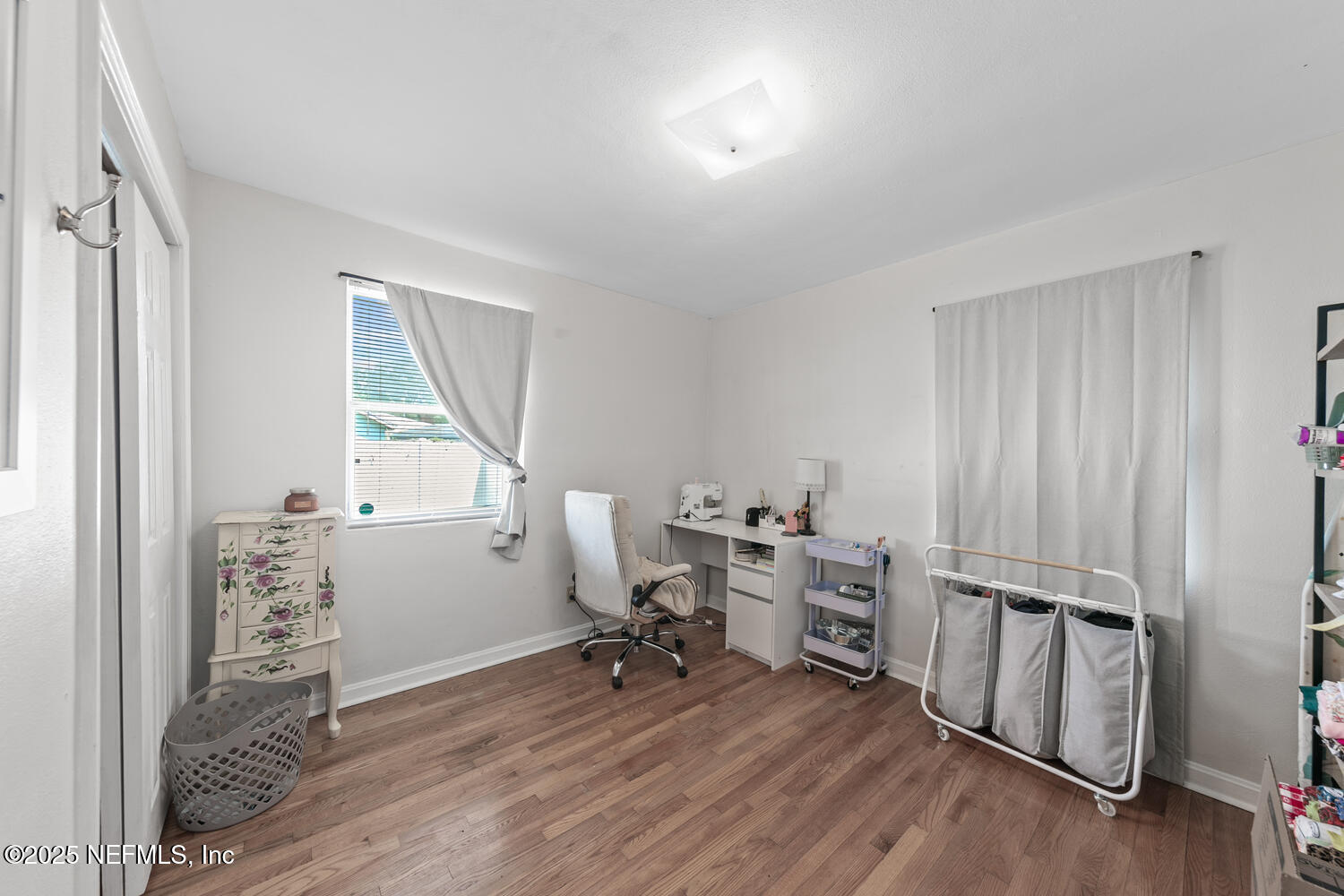 8309 Calento Street Jacksonville, FL 32211 - Photo 17 of 22 a view of workspace with wooden floor and windows