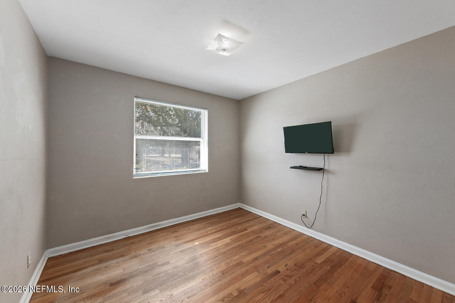8309 Calento Street Jacksonville, FL 32211 - Photo 18 of 25 a view of room with wooden floor and ceiling fan