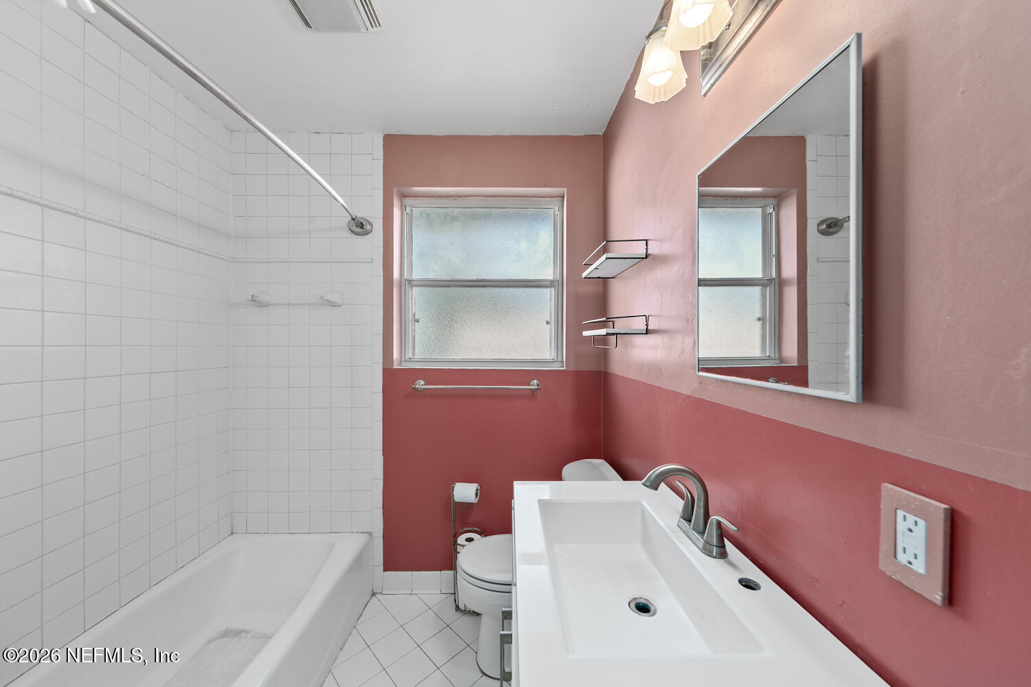 8309 Calento Street Jacksonville, FL 32211 - Photo 20 of 25 a bathroom with a sink mirror and toilet