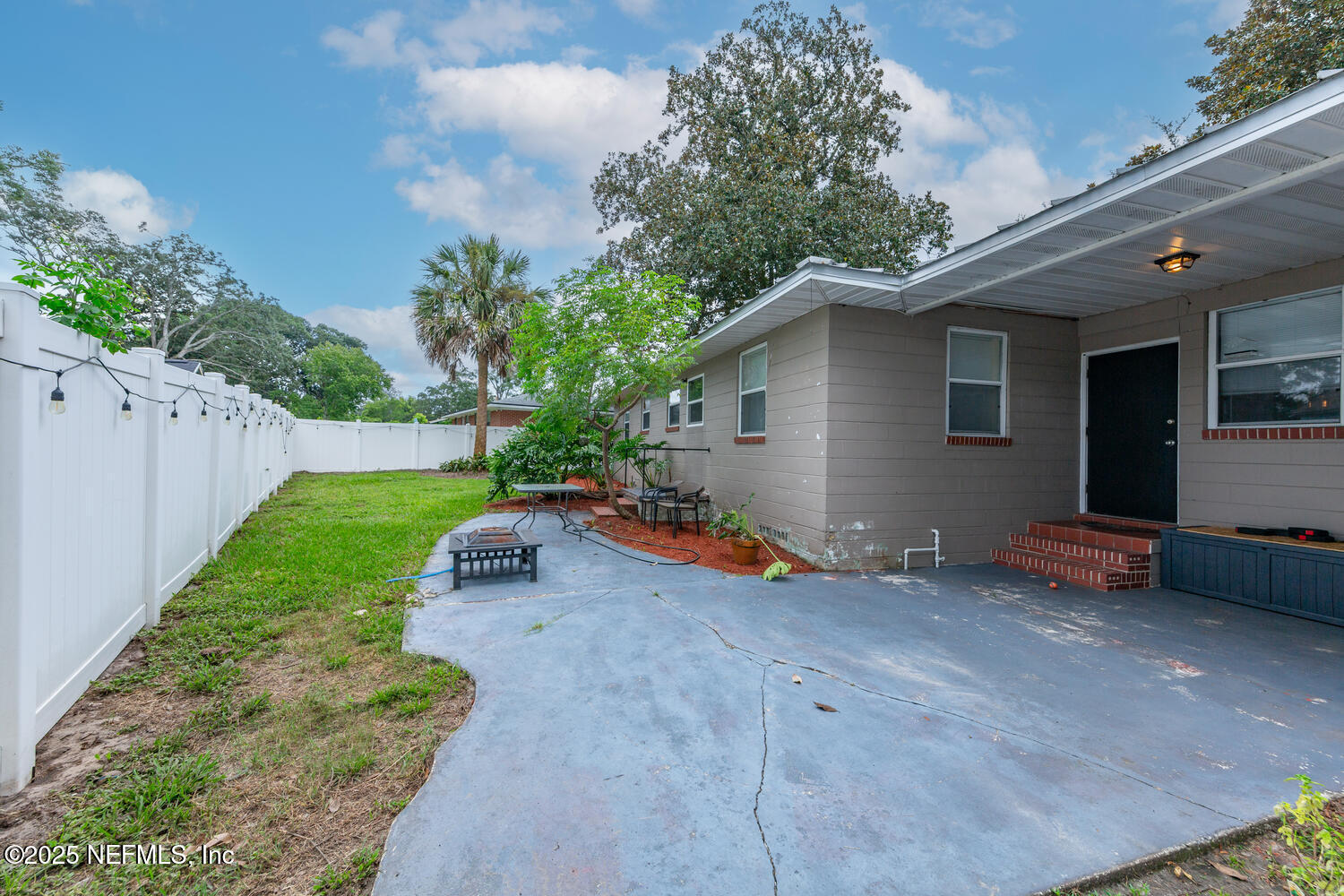 8309 Calento Street Jacksonville, FL 32211 - Photo 21 of 25 a view of a backyard with plants and a bench