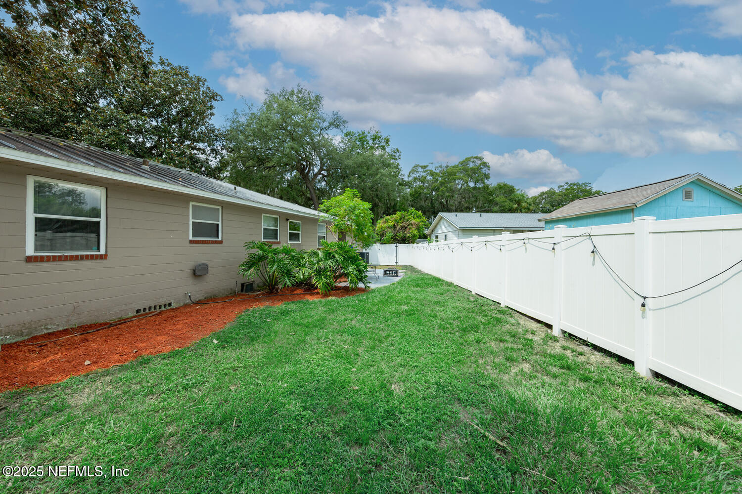 8309 Calento Street Jacksonville, FL 32211 - Photo 25 of 25 a view of backyard with seating space and trampoline
