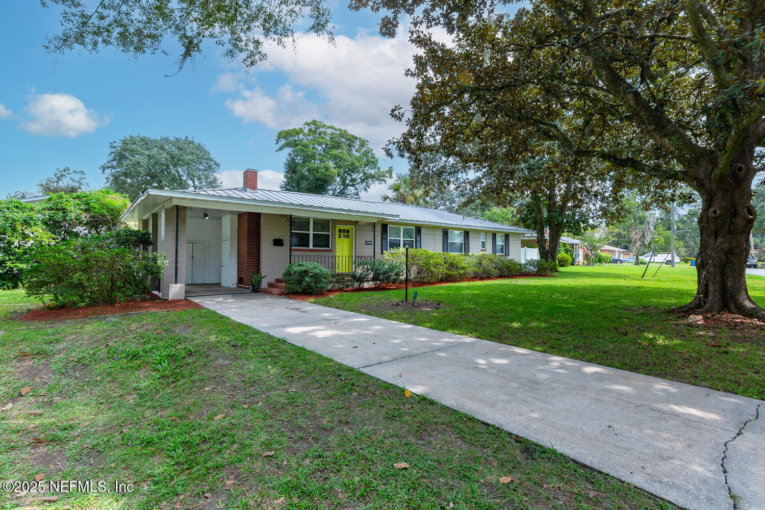 8309 Calento Street Jacksonville, FL 32211 - Photo 3 of 22 a view of house in front of a big yard with large trees