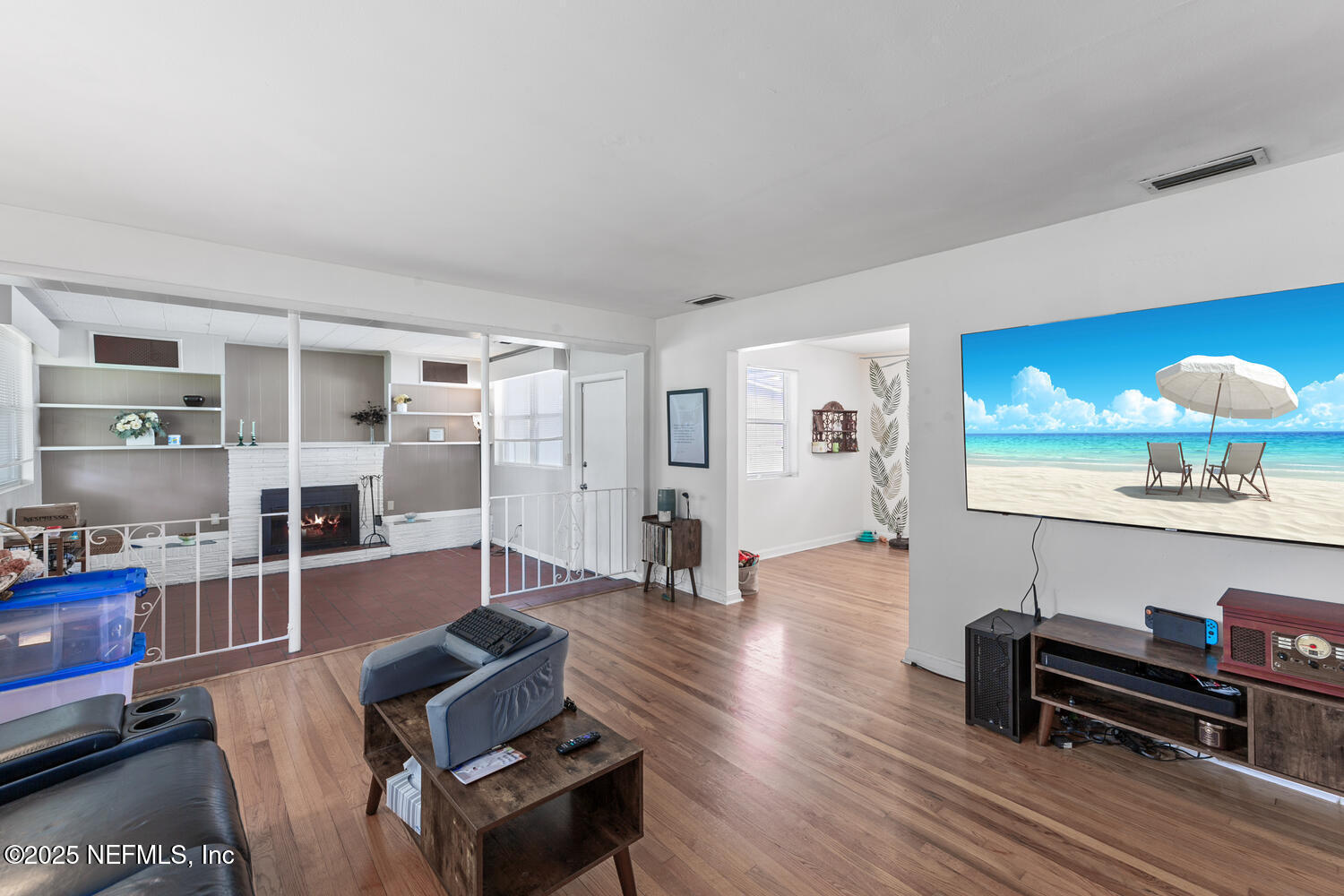 8309 Calento Street Jacksonville, FL 32211 - Photo 6 of 22 a living room with furniture a flat screen tv and a wooden floor