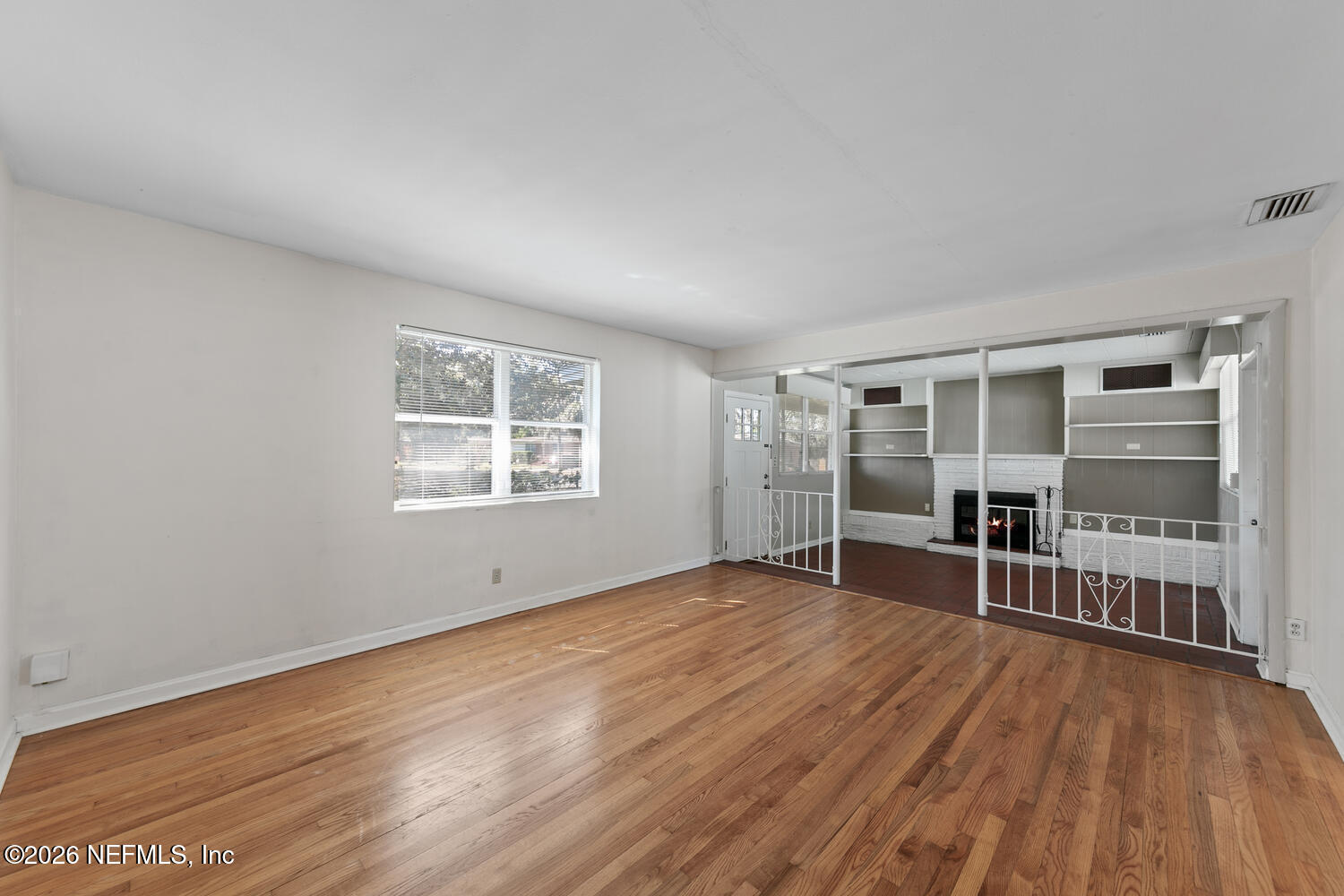 8309 Calento Street Jacksonville, FL 32211 - Photo 9 of 25 a view of a livingroom with wooden floor and windows
