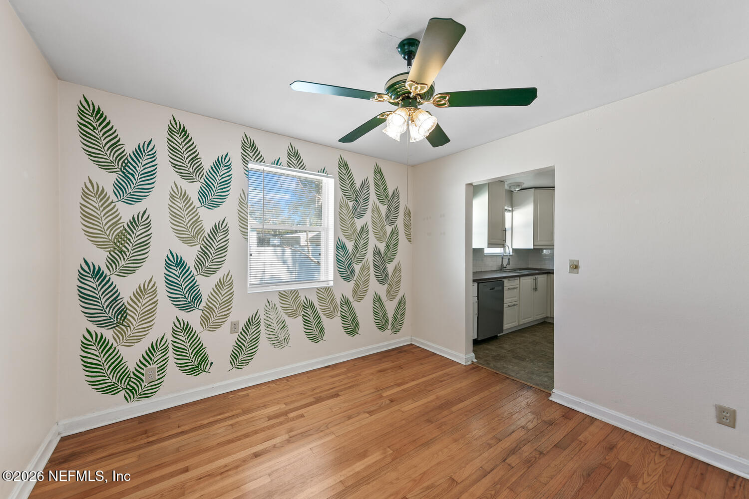 8309 Calento Street Jacksonville, FL 32211 - Photo 10 of 25 a view of empty room with wooden floor and fan