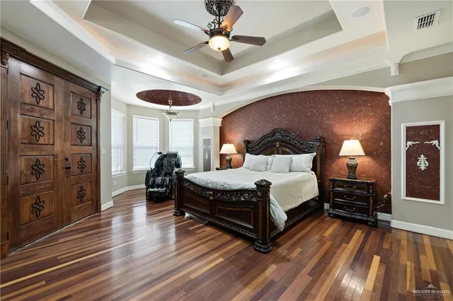a spacious bedroom with a bed and a chandelier