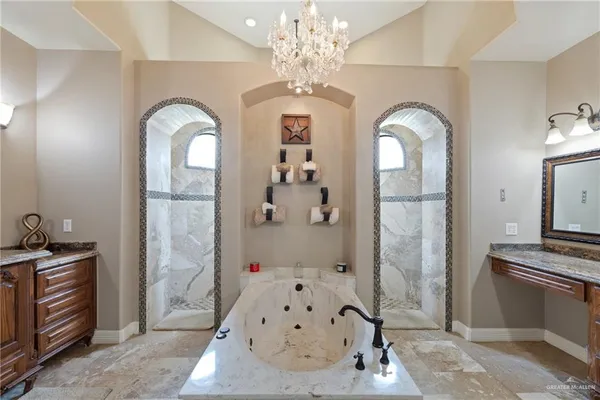 a view of a livingroom with a fireplace chandelier and entryway