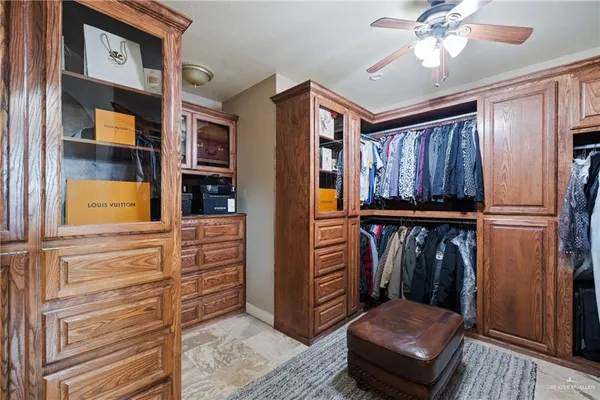 a view of hallway with furniture and a chandelier