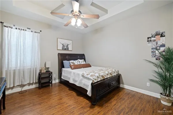 a bedroom with a bed and a potted plant