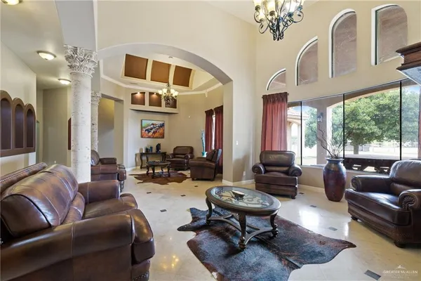 a living room with furniture fireplace and a large window