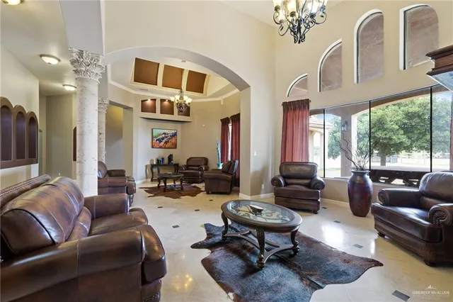 a living room with furniture fireplace and a large window