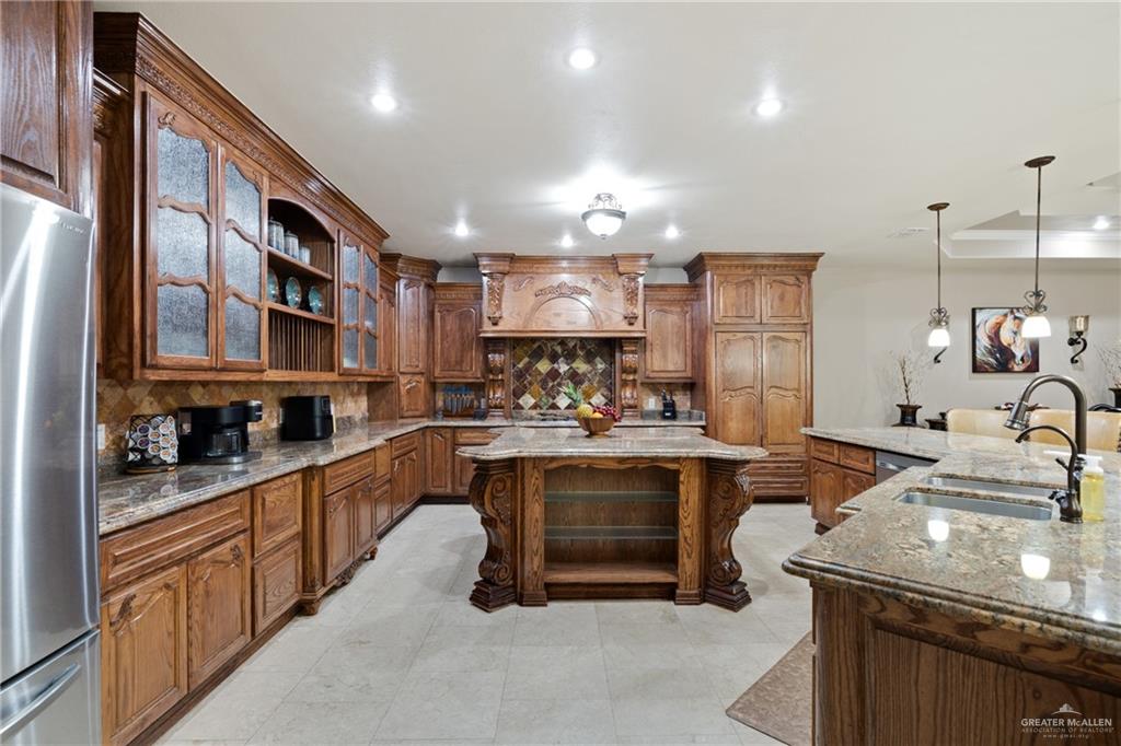 22209 Uresti Road Edinburg, TX 78542 - Photo 7 of 38 a kitchen with stainless steel appliances granite countertop a sink stove and cabinets