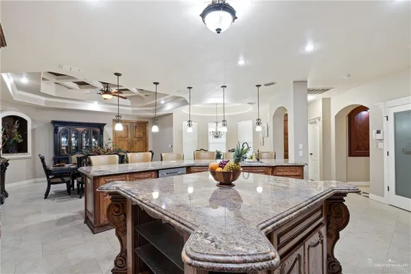a large kitchen with a table and chairs