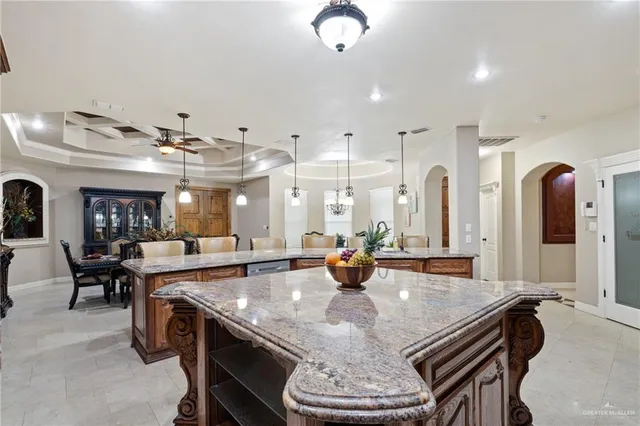 a large kitchen with a table and chairs