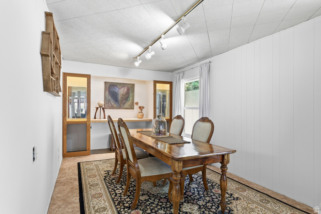 365 North Main Street Fillmore, UT 84631 - Photo 18 of 51 Recessed wall niches with built-in shelving, track lighting, white paneled wall accents, and an overhead acoustic tile ceiling
