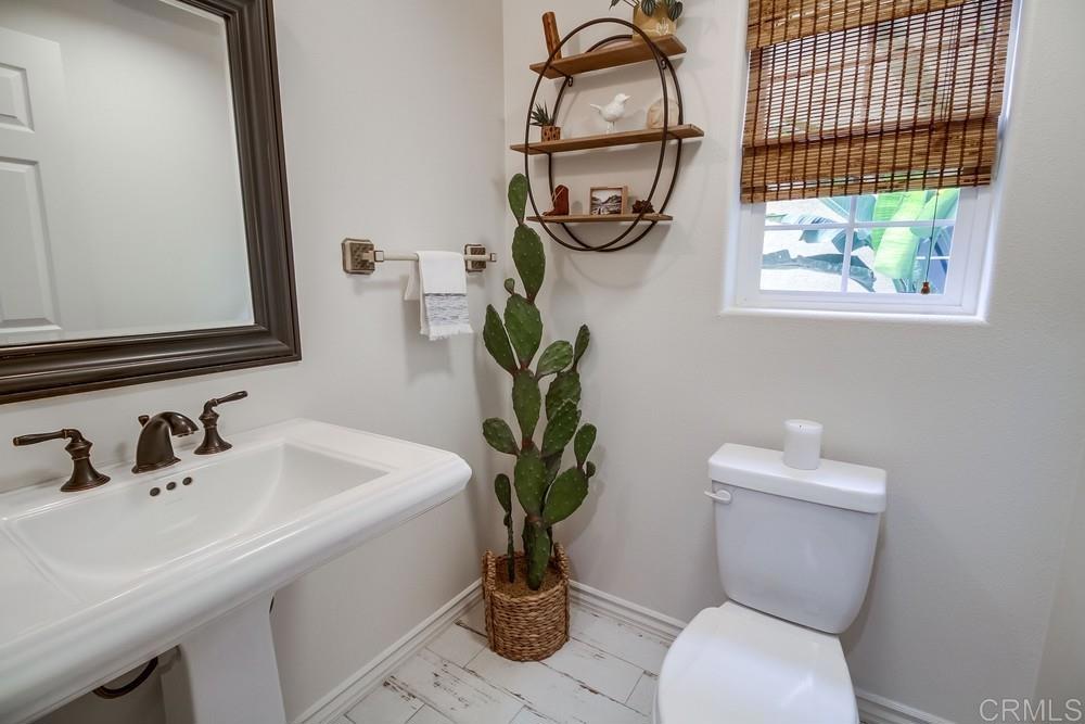 501 Beach Street Encinitas, CA 92024 - Photo 10 of 16 a bathroom with a toilet sink and mirror