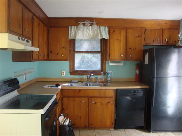 118 High Street Rochester, MA 02770 - Photo 2 of 13 a kitchen with a sink cabinets and a refrigerator
